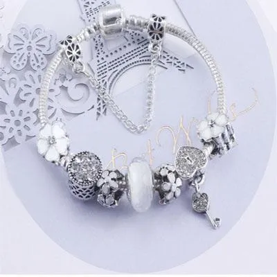 Charming White and Silver bracelet with Heart Locket and Flower themed charms